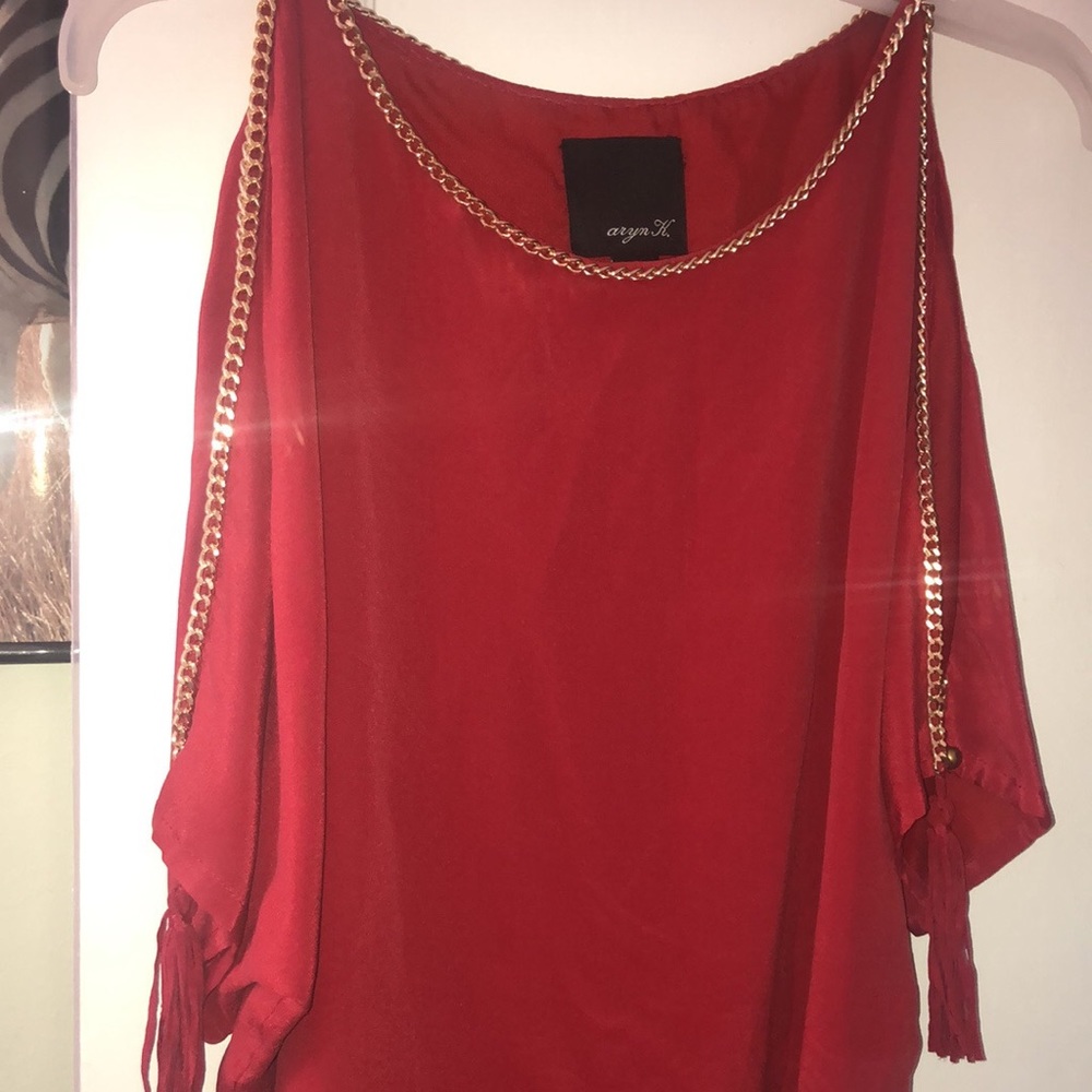 Red blouse with gold chain trim